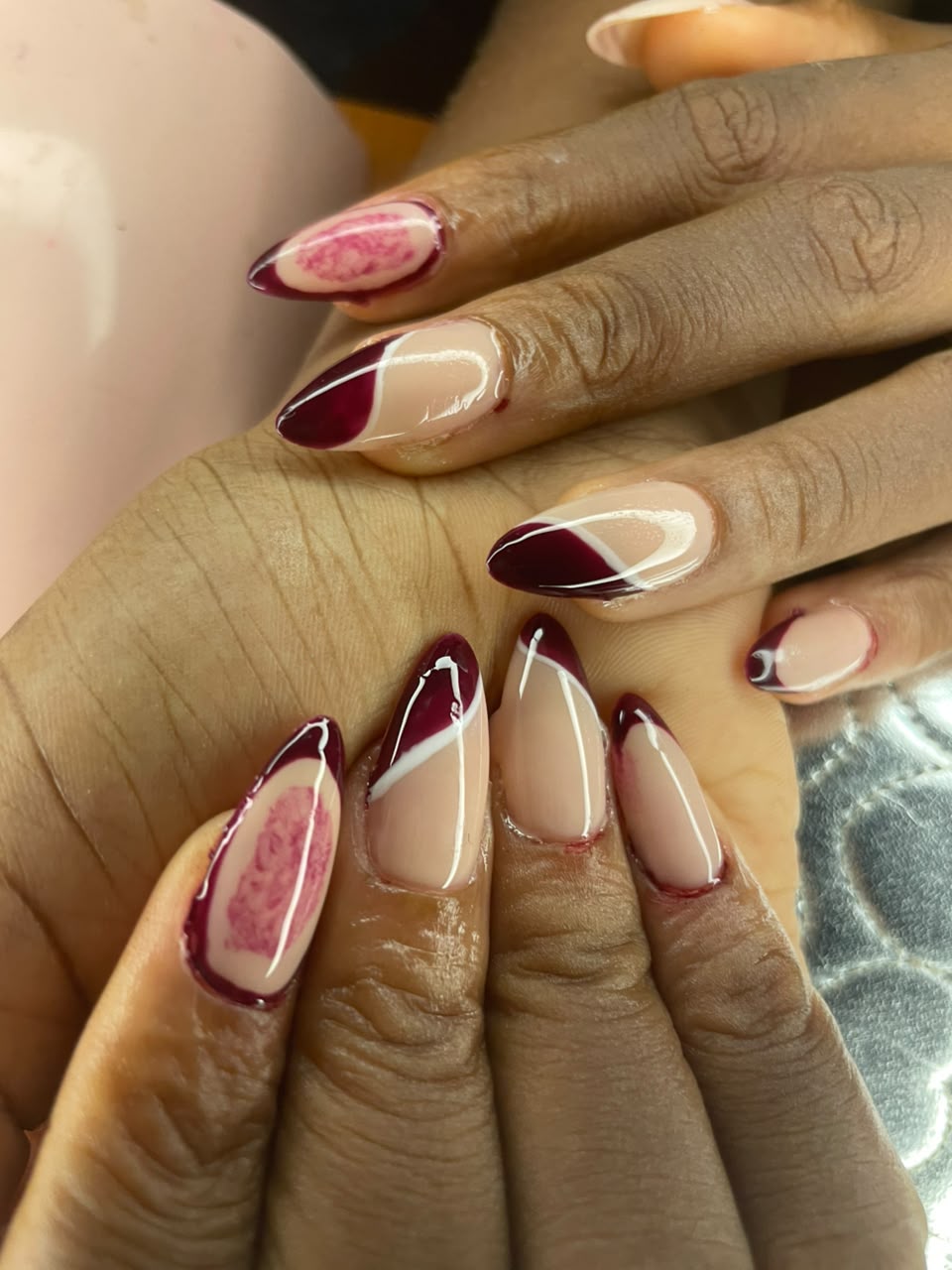 Burgundy and nude line-art nail design